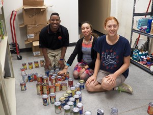 Organizing canned goods in Fall Creek Township food pantry