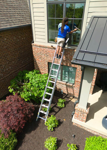 Northside Window and Gutter Cleaning on ladder