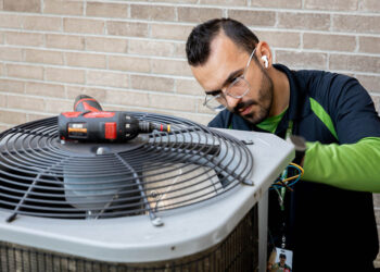 heat pump being serviced by technician
