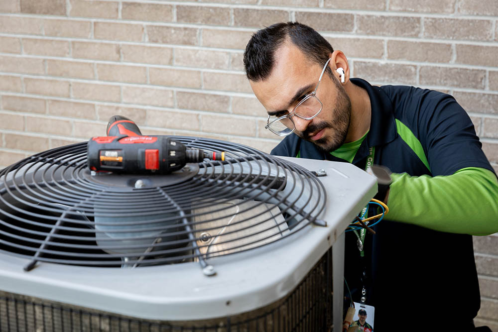 heat pump being serviced by technician