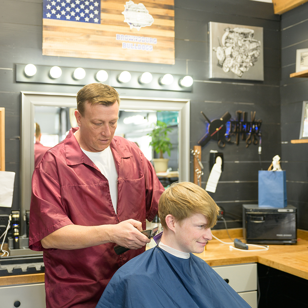 Freddie Niblack cutting hair at Garage 17 Barbershop