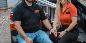 Storm Warrior Roofing Owner and Office Manager sitting on truck