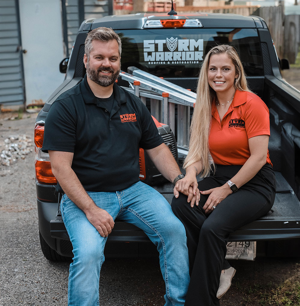 Storm Warrior Roofing Owner and Office Manager sitting on truck