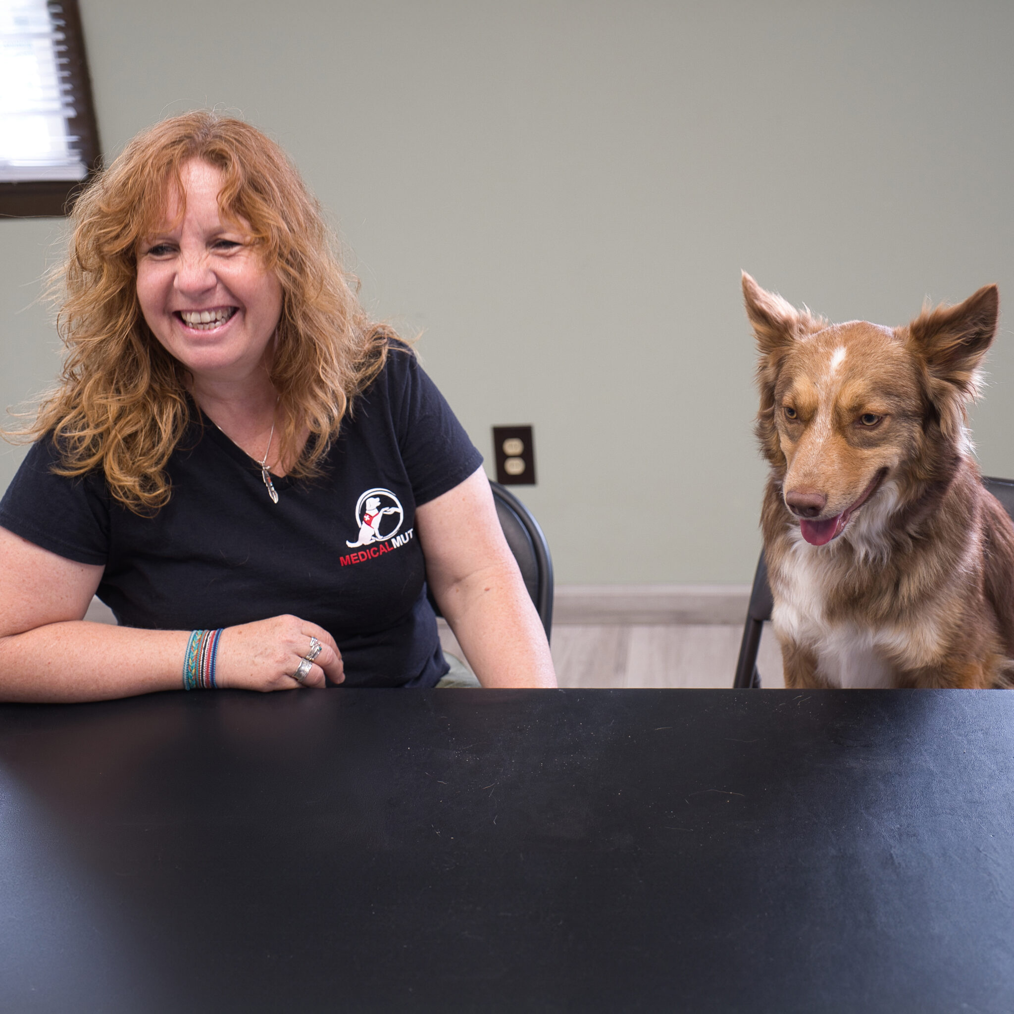 Woman smiling next to a future service dog