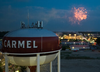 Fireworks over the Carmel, Indiana skyline with the water tower