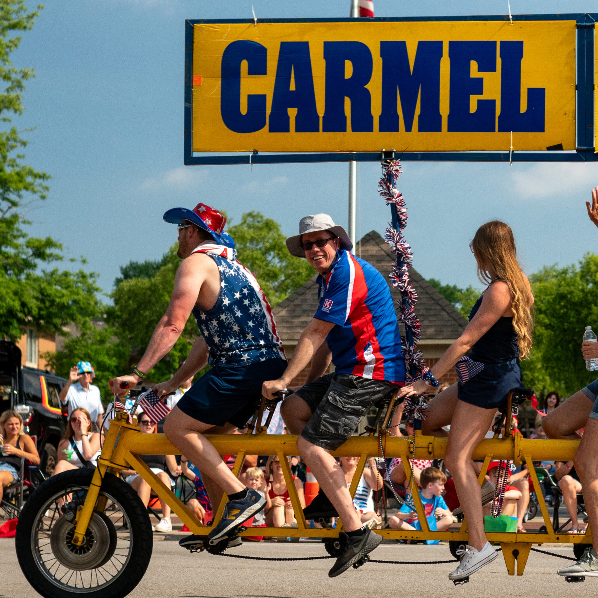 People on a tandem bike in a parade