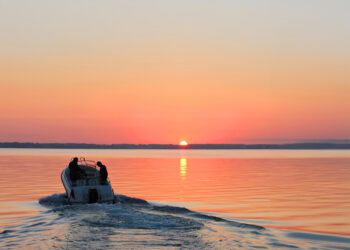 Boat on the water with the sun setting