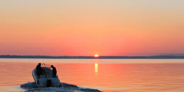 Boat on the water with the sun setting