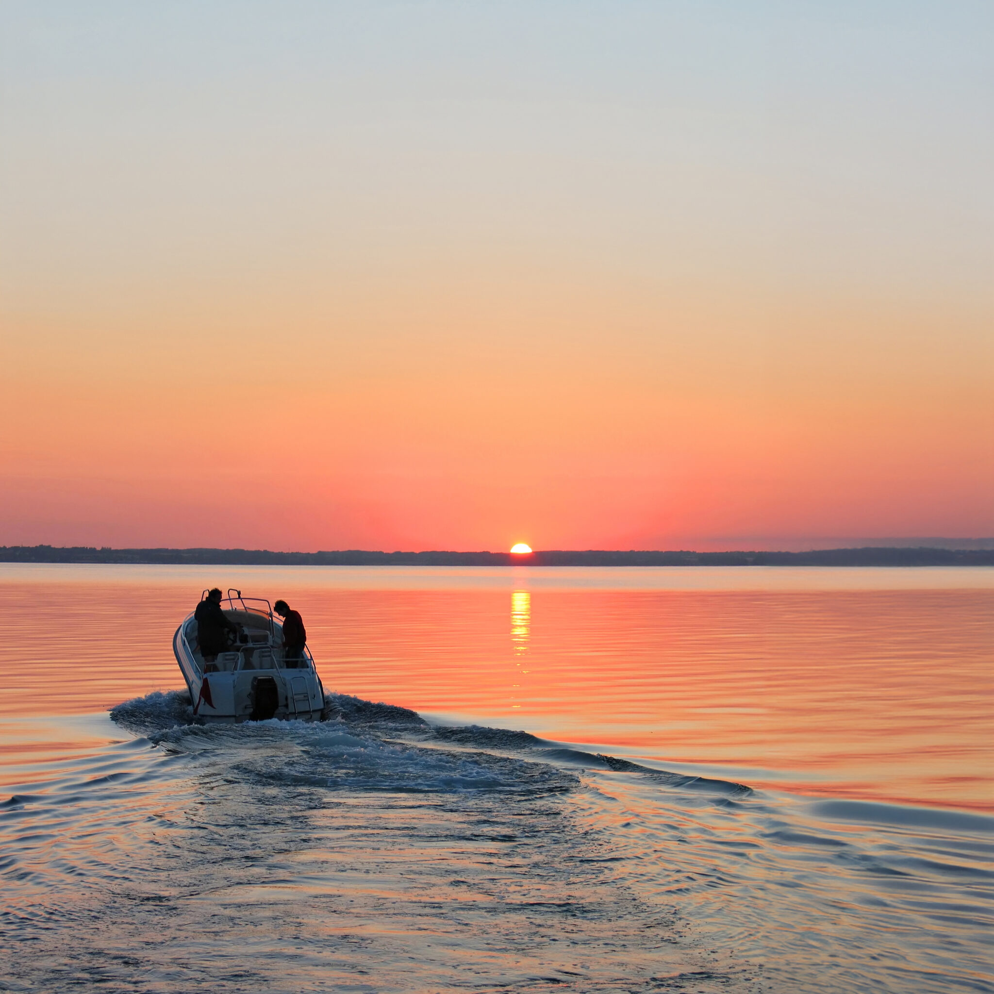 Boat on the water with the sun setting