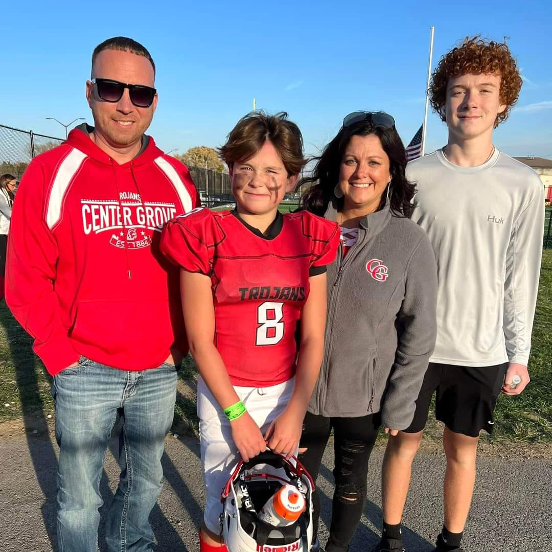 Greenwood real estate agent with her husband and sons after a football game