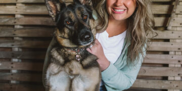 Woman holding a german shepherd dog