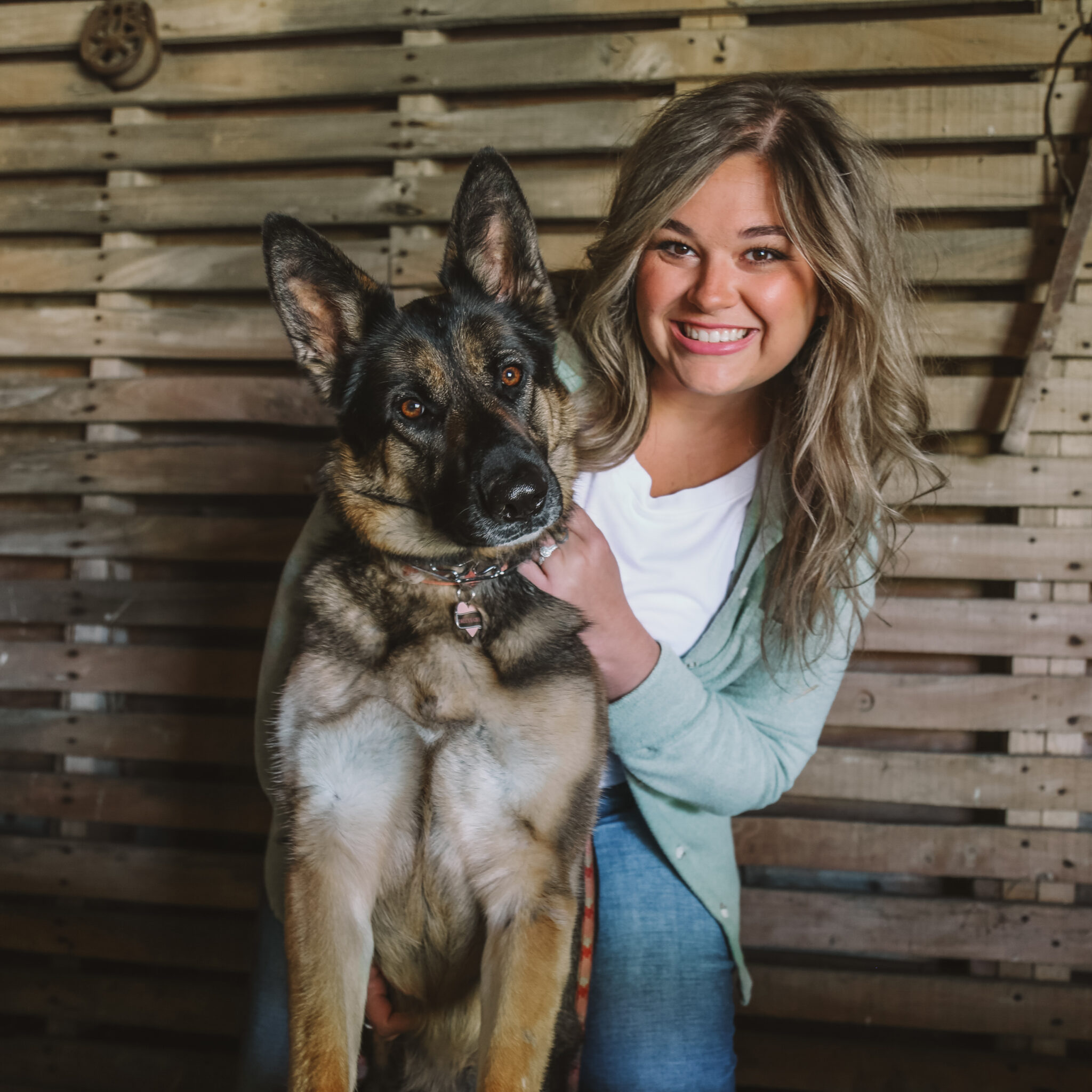 Woman holding a german shepherd dog