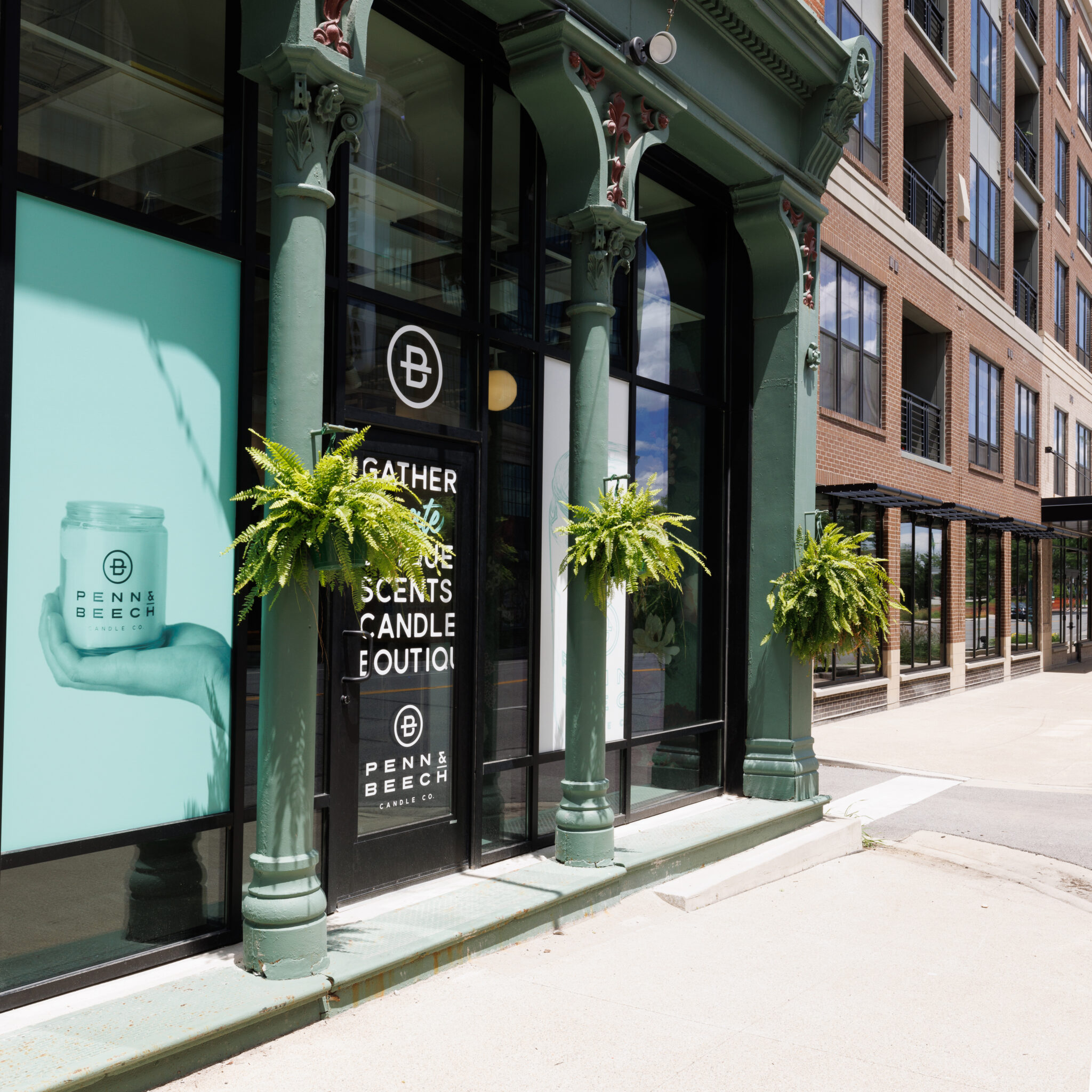 Storefront with ferns in front of the door