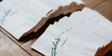 SAHMS catering napkins stacked on a wooden table