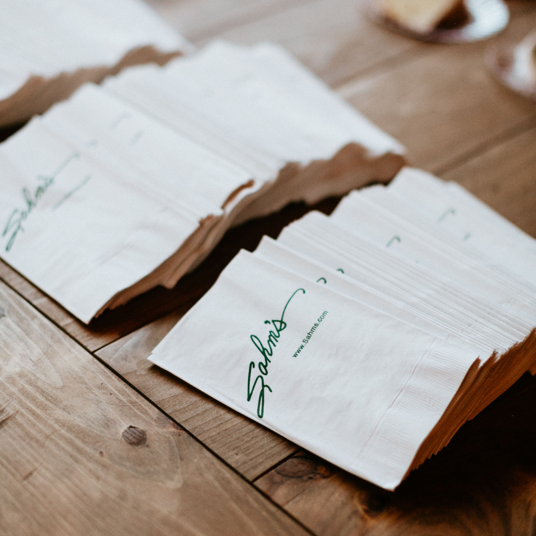 SAHMS catering napkins stacked on a wooden table