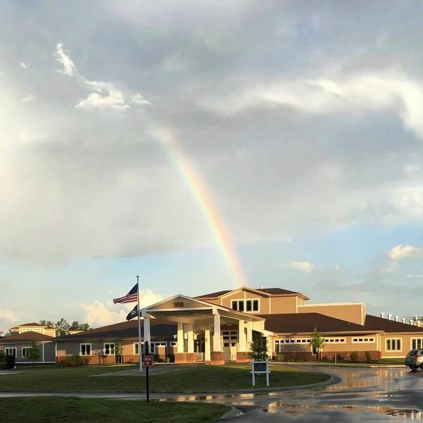 Community center with rainbow overhead