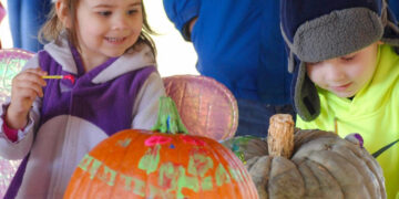 Kids painting pumpkins