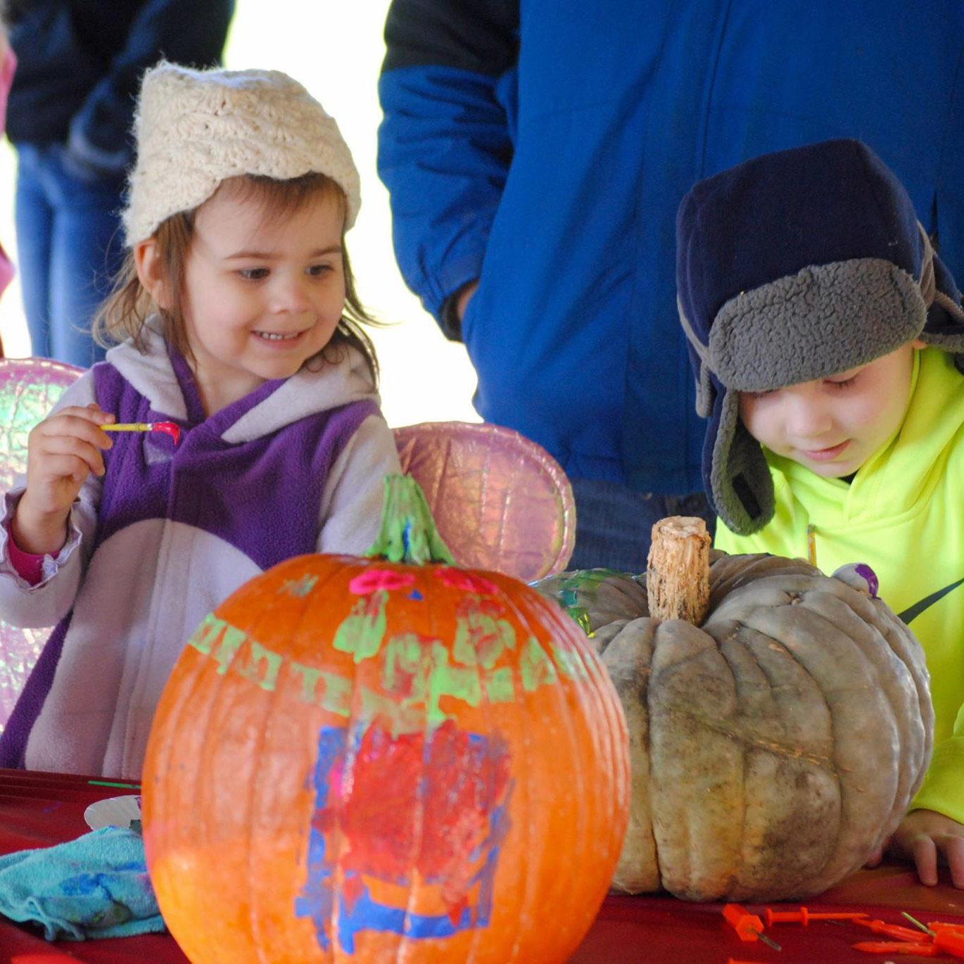 Kids painting pumpkins