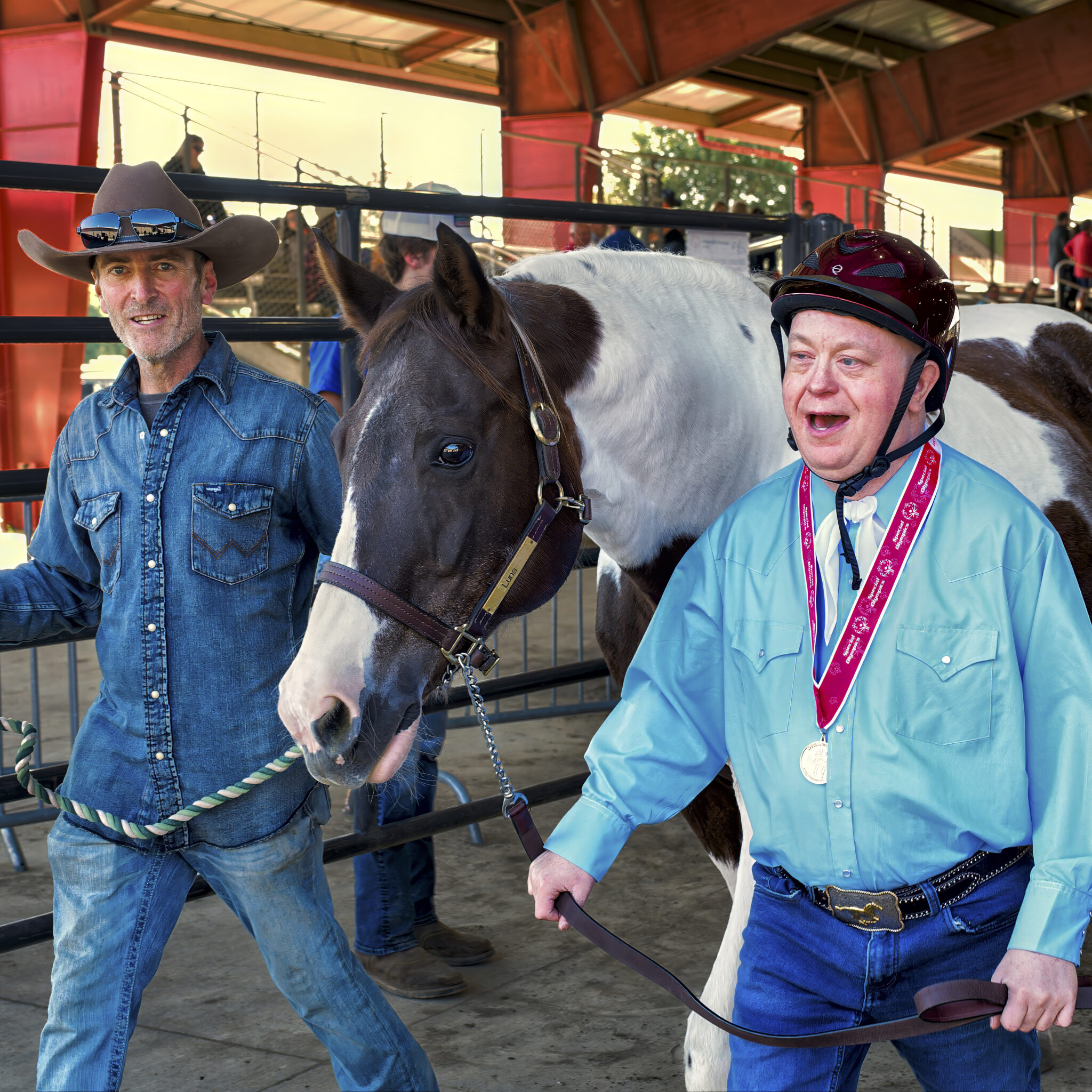 Two men escorting a show horse into a ring