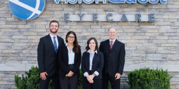 Eye doctors in front of a sign