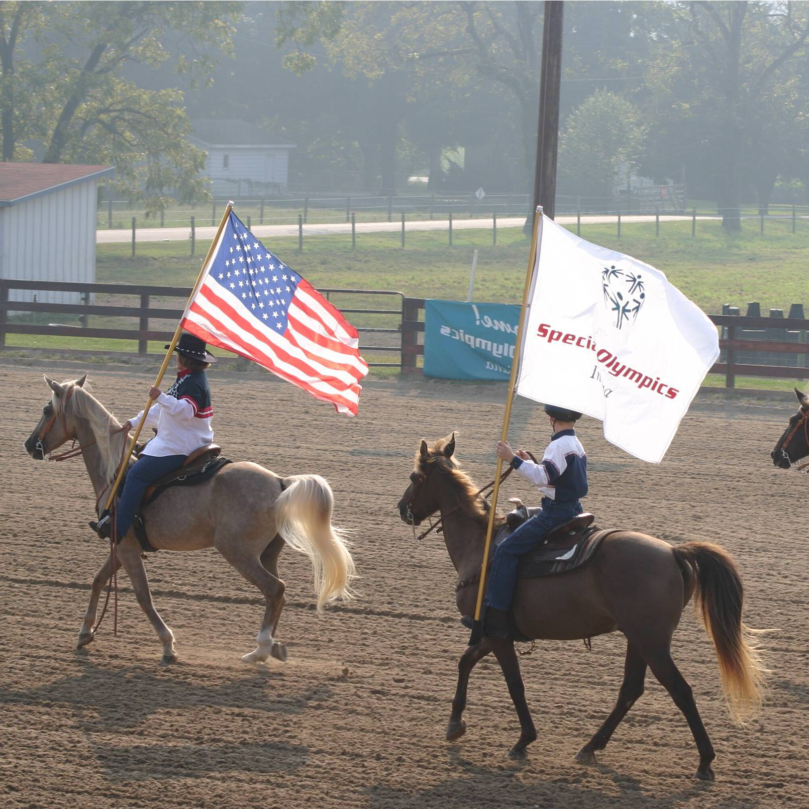 Flags flying by horseback riders at the Hendricks County Fairgrounds