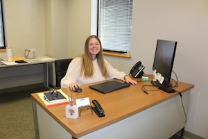 Kiley Chandler sitting at her desk