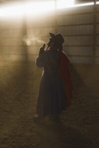 A cowboy in a barn