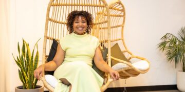Owner of Pure Green Fishers Chasten Harmon sitting in a hanging chair