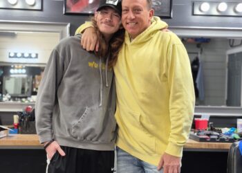 Freddy Niblack standing with a customer in the Barber Shop