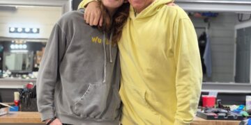 Freddy Niblack standing with a customer in the Barber Shop