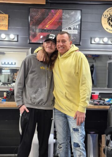 Freddy Niblack standing with a customer in the Barber Shop