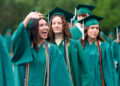 Zionsville High School graduates in green cap and gowns.