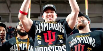 Kaden McConnell lifting the National Championship Trophy