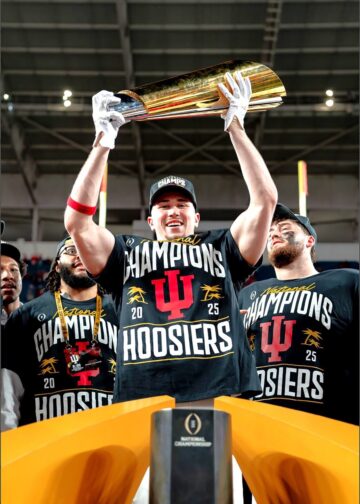 Kaden McConnell lifting the National Championship Trophy