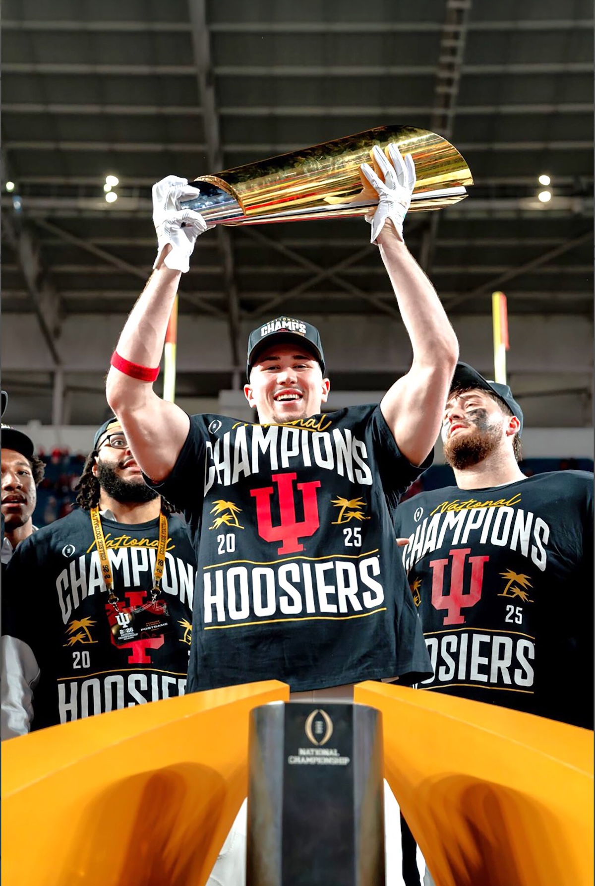 Kaden McConnell lifting the National Championship Trophy