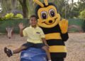 Kid City mascot with a child at the park
