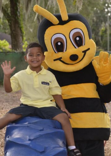 Kid City mascot with a child at the park