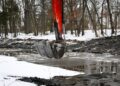An excavator digging out a pond