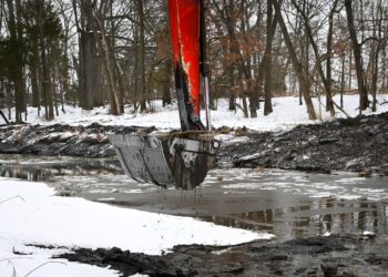 An excavator digging out a pond