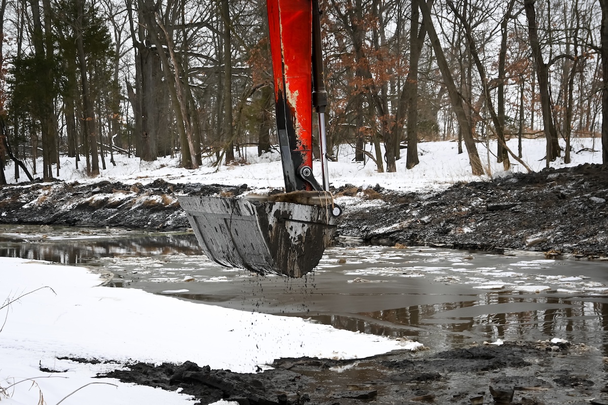 An excavator digging out a pond
