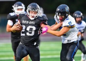 Brock Nauman of Wes-Del High School runs with the football