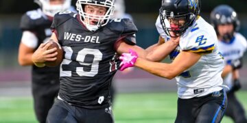 Brock Nauman of Wes-Del High School runs with the football