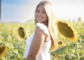 Taylor Freeman standing in a sunflower field