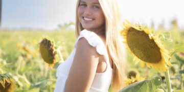 Taylor Freeman standing in a sunflower field