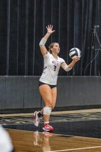 Taylor Freeman about to serve the volleyball