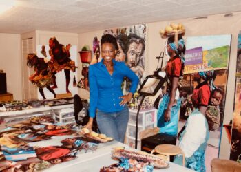 Licia Priest in her art studio with her art work