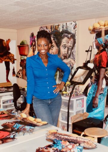 Licia Priest in her art studio with her art work