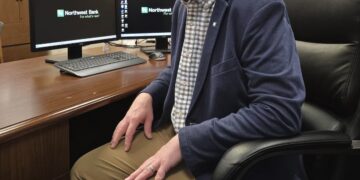 Matt Anderson sitting at his desk at Northwest Bank