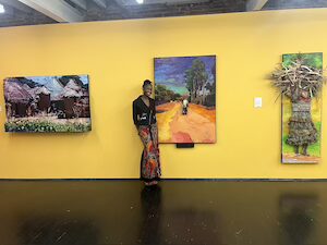 Licia Priest standing with her art in an art museum
