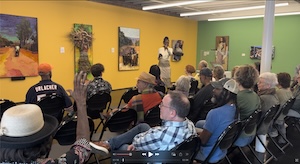 Licia Priest standing with her art in an art museum